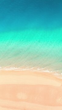 Clean empty tropical beach with azure waves. Aerial background vertical video