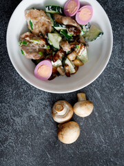 warm salad with chicken breast, mushrooms, egg and fresh arugula.