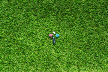 Mouthpiece for shisha om the green grass backround. Plastic waste concept. Plastic trash garbage, save nature. Parts of hookah, tobacco Hookah Shisha Mouthpiece on grass background.