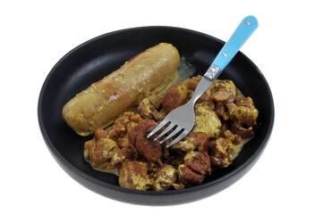 Assiette de boudin blanc avec des marrons à la crème et une fourchette en gros plan sur fond blanc