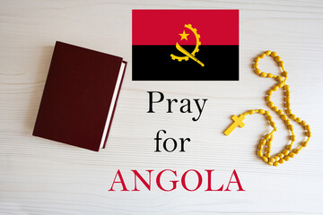 Pray for Angola. Rosary and Holy Bible background.
