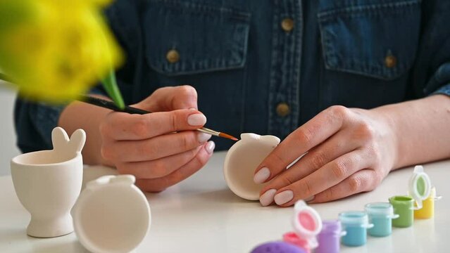 Pastel color Easter egg holder. Woman preparing for spring holiday	
