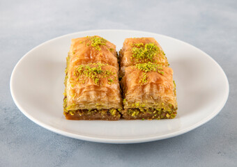 Pistachio Turkish baklava on a white plate.Traditional delicious Turkish baklava
