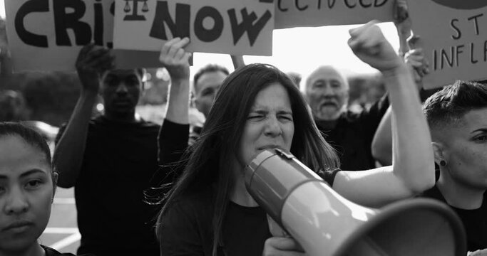 Group of multiracial people protesters walking in the city against inflation and financial crisis - Protesters marching for rise cost of living - Black and white editing