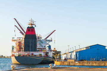 Cargo ship with cranes docked in industrial port, South Australia