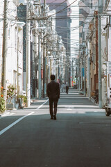 a man walks alone on the street of tokyo