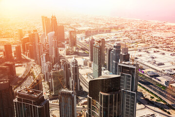 Dubai skyline on sunset, modern city with skyscrapers