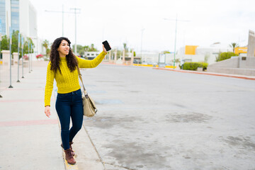 Beautiful woman in the city using a ride share app