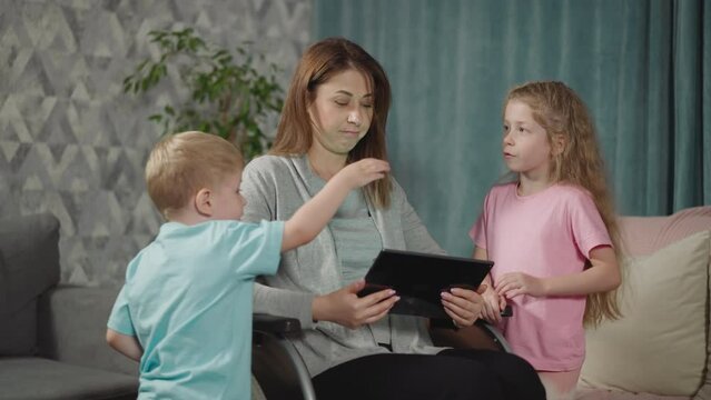 Mother listens to blond son talking while watching cartoon