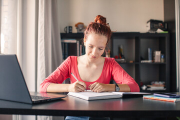 Millennial student sit at desk study on laptop