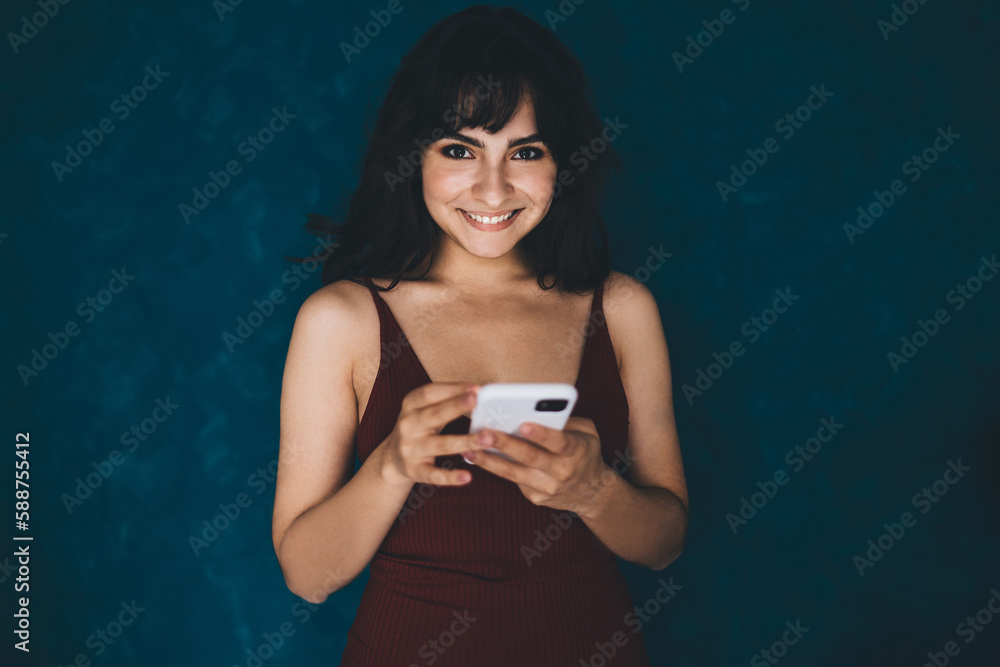 Aufkleber portrait of gorgeous smiling woman standing with mobile phone on copy space background. caucasian la
