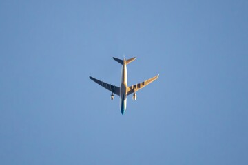 Commercial airplane flying over a clear sky at sunset, close-up, copy space, concepts.