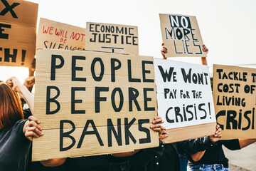 Crowd of multiracial people protest against inflation and financial crisis - Protesters marching...