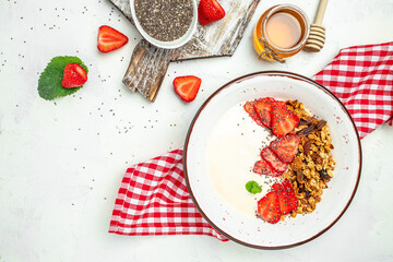 Fresh breakfast with greek yogurt nuts oatmeal granola with berries in a bowl. Delicious breakfast or snack, top view