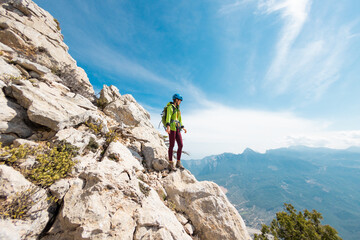 climber goes along the rocky ridge. girl climbing in the mountains. Turkey. the concept of...