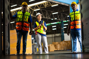 Fototapeta premium Group of warehouse asian indian workers wearing safety hardhats helmet inspection in container at warehouse. E-Commerce Goods at Logistics Warehouse factory.warehouse interior with shelves, pallets 