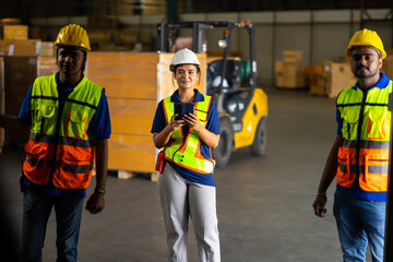 Group of warehouse asian indian workers wearing safety hardhats helmet inspection in container at warehouse. E-Commerce Goods at Logistics Warehouse factory.warehouse interior with shelves, pallets 