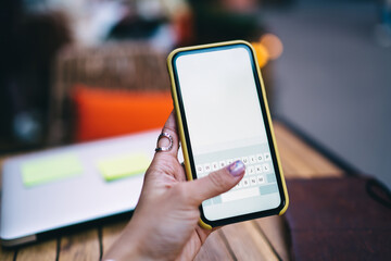 Unrecognizable woman messaging via smartphone