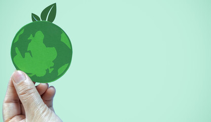 Hand holding paper cut saving clean energy earth globe world environment green eco friendly, save planet, csr social responsibility.campaign save the earth and earth Day 22 April