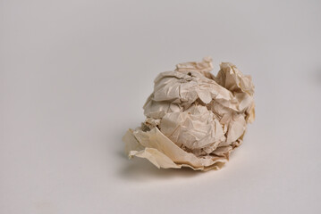 Crumpled brown paper on a white background. concept of disappointment, failure