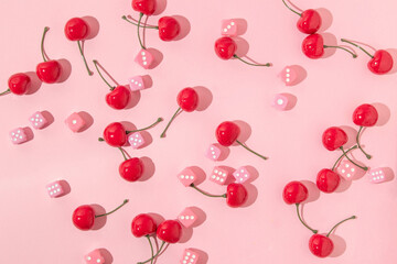 Summer creative pattern with cherries and pink dices on pastel pink background. 80s or 90s retro...