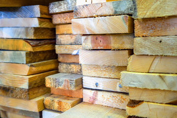 Wooden boards are stacked in a sawmill or carpentry shop. Drying and marketing of wood..