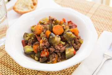 Fototapeta premium dish of vegetable stew. stewed eggplant, minced meat, carrots, peppers, onion squid
