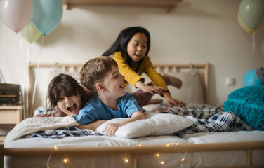 Obraz premium Three happy friends having fun together in a room.