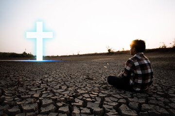 Man hand pray with cross for protecting environment from water crisis and the impact of climate...