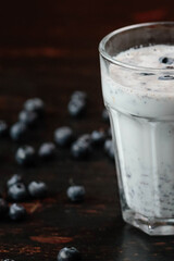 blueberry smoothie and fresh berry on the dark background. Concept healthy eating