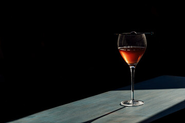 Manhattan cocktail on a table top with a dark background