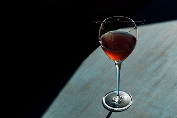Manhattan cocktail on a table top with a dark background