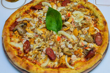 Hot dog and seafood pizza on a white background