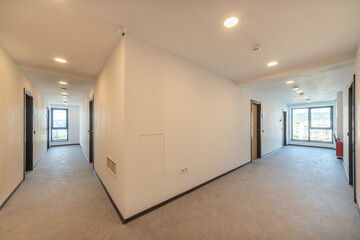 Interior of a hotel corridor doorway. Narrow hallway with closed doors. Campus