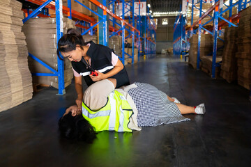 Woman Security guards helping fat women who lose consciousness due to heart disease or stroke at warehouse factory workplace