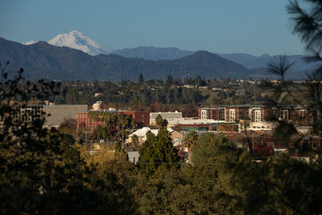 Afternoon snow covered view of the peak of Mount Shasta and the downtown skyline of Redding,...