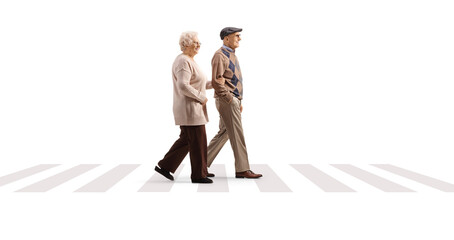 Full length profile shot of an elderly woman holding an elderly man under arm and crossing a pedestrian zebra - obrazy, fototapety, plakaty