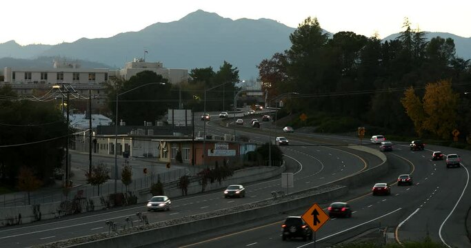 Sunset traffic passes on CA-44 through downtown Redding, California, USA.