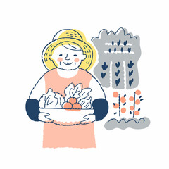 収穫した野菜を持っているシニア女性