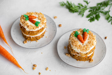 Easter Carrot cake Rüeblitorte with cream cheese frosting and marzipan decorations for festive dinner. Small easter bento cake. Fresh homemade carrot dessert. Traditional Easter food.