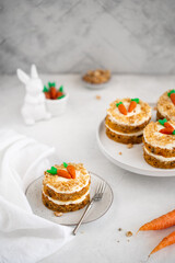 Easter Carrot cake Rüeblitorte with cream cheese frosting and marzipan decorations for festive dinner. Small easter bento cake. Fresh homemade carrot dessert. Traditional Easter food.