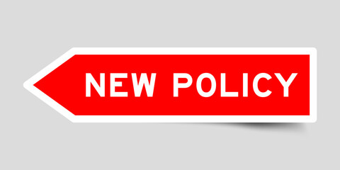 Red color arrow shape sticker label with word new policy on gray background