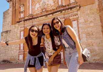 Three beautiful smiling friends hugging, group of women looking at camera, Lifestyle traveling, happy single women, tourists having fun, Vacation concept and lifestyle traveling.