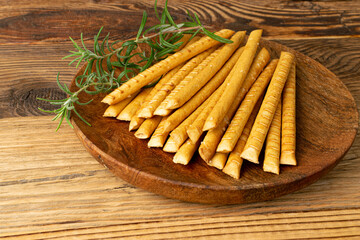 Bread Sticks on Wood Plate, Salted Breadstick, Crispy Grissini, Dry Homemade Pretzel on Wooden Background