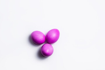 Three pink Easter eggs on white background