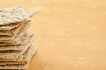 Matzah Passover celebration concept. Traditional ritual Jewish bread on sand color old wall...