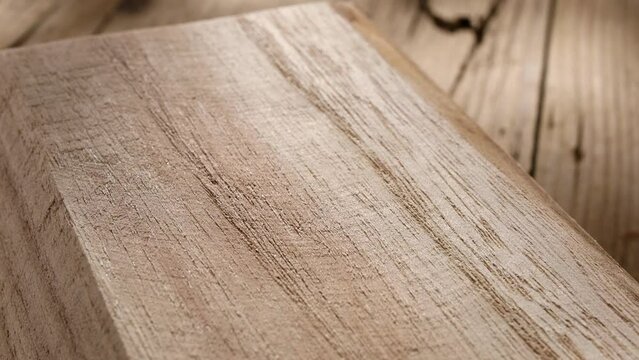 new craftwood product on an old wooden surface with cracks. wood texture closeup. place in a carpenter's workshop with spots of light. detail scene.