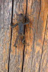 A close-up of a metal figurine of a man made by a blacksmith
