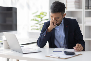 Stressed Asian man in office work in office documents money financial planning concept