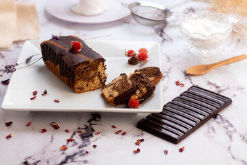 Rectangular marbled vanilla and chocolate pudding cupcakes with a chocolate bar and decorated with...